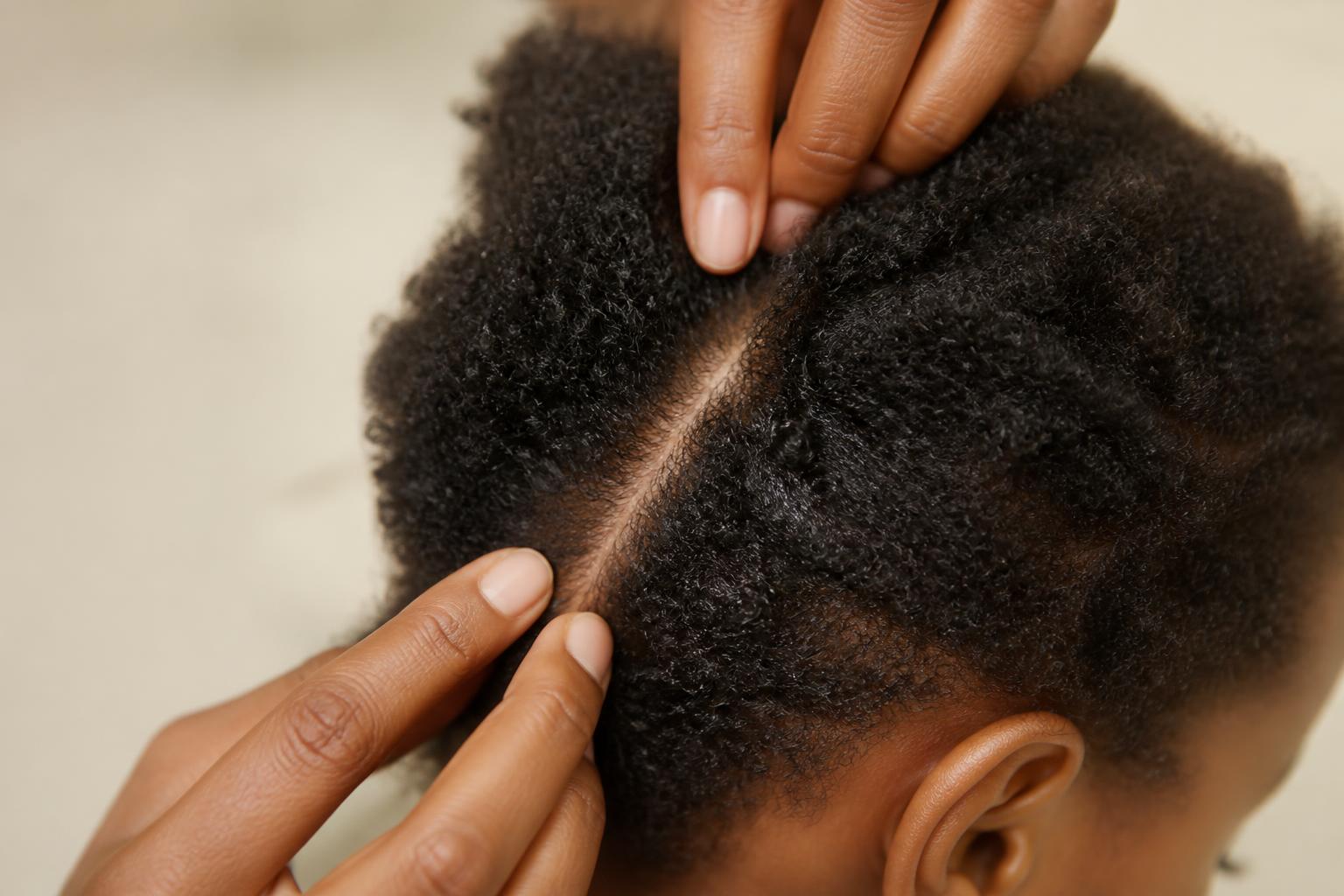 Close editorial study of a child's curls and scalp parting, Little Novaé paediatric trichology